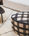 Petit pouf rond en tissu à motifs 