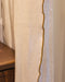 Détail du bourdon couleur Tabac du rideau en lin 
